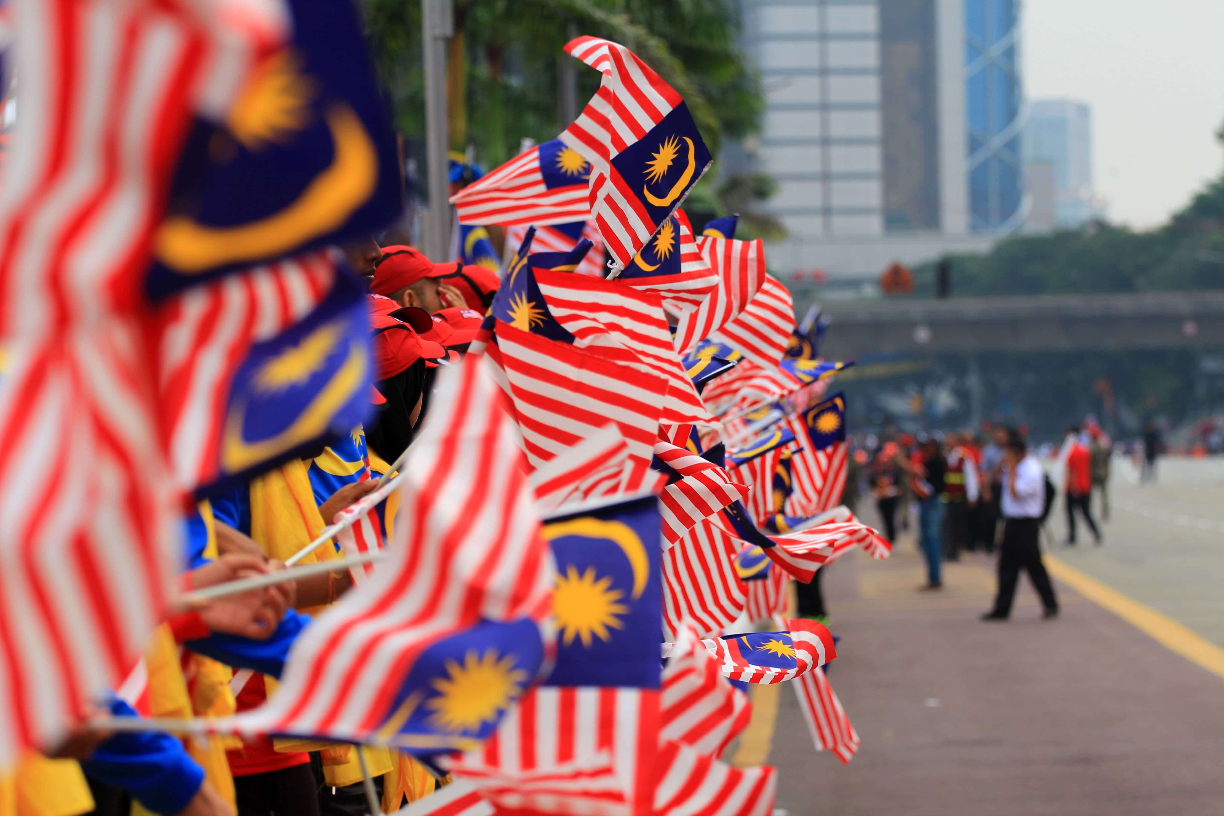 People waving Malaysian flags